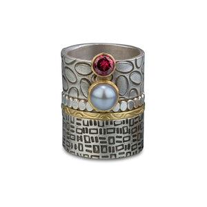 Signature patterns in sterling silver and gold. Accented with Rhodolite garnet and dove grey pearl set in 18k gold.